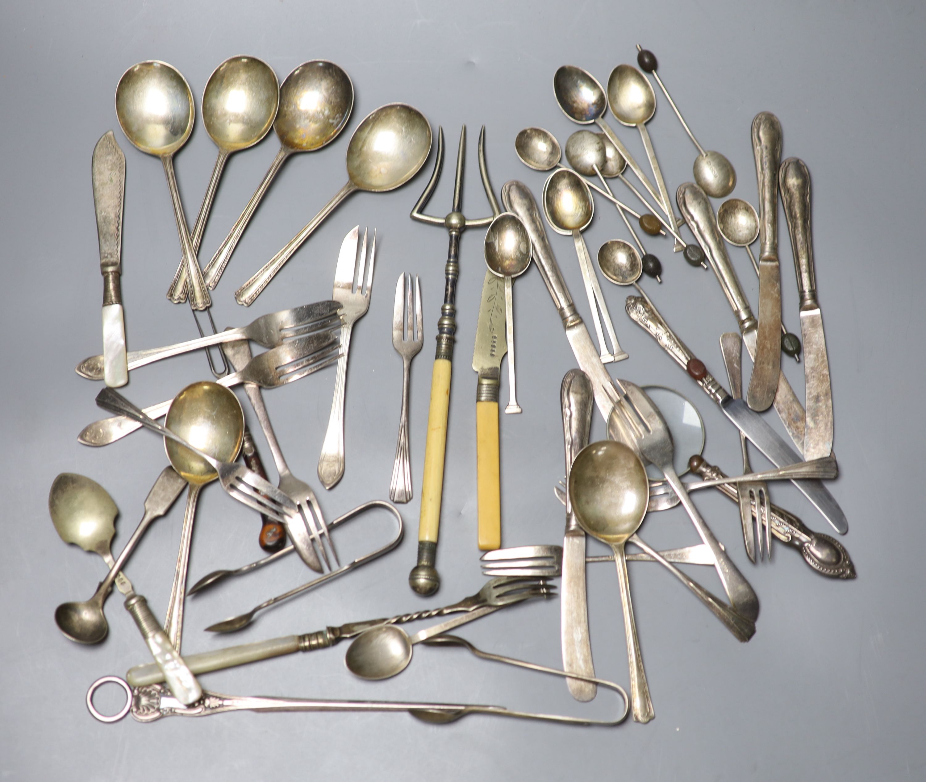 Two sets of silver spoons including bean end coffee spoons, six silver handled tea knives and a silver handled magnifyer etc.